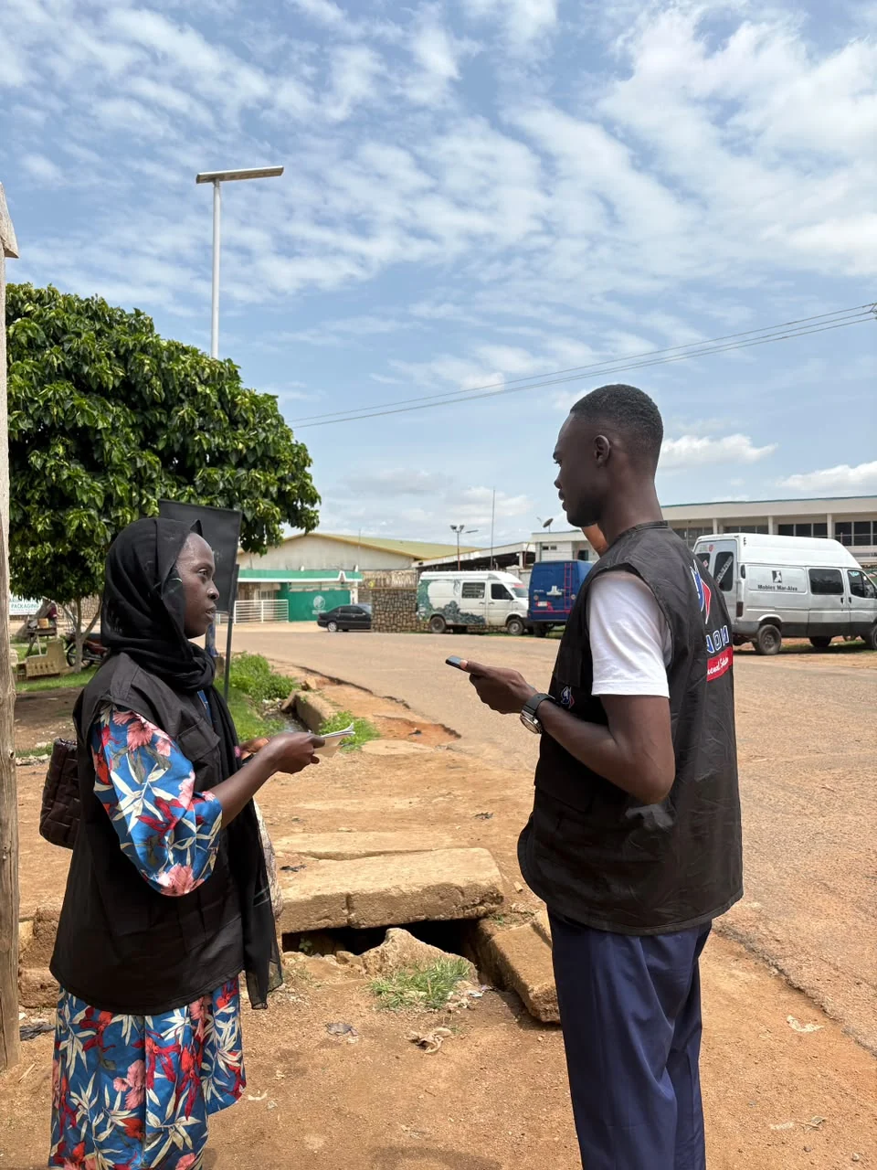 FINOM field team speaking with a community member